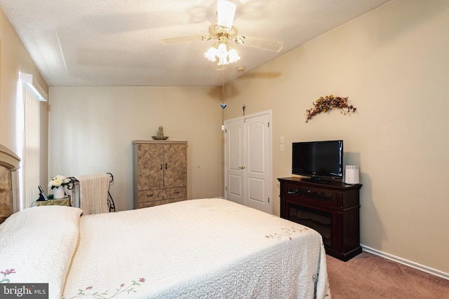 bedroom featuring carpet floors, vaulted ceiling, and ceiling fan