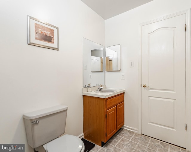 bathroom with vanity, tile patterned flooring, and toilet