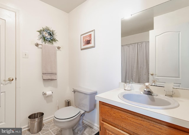 bathroom with tile patterned flooring, vanity, and toilet