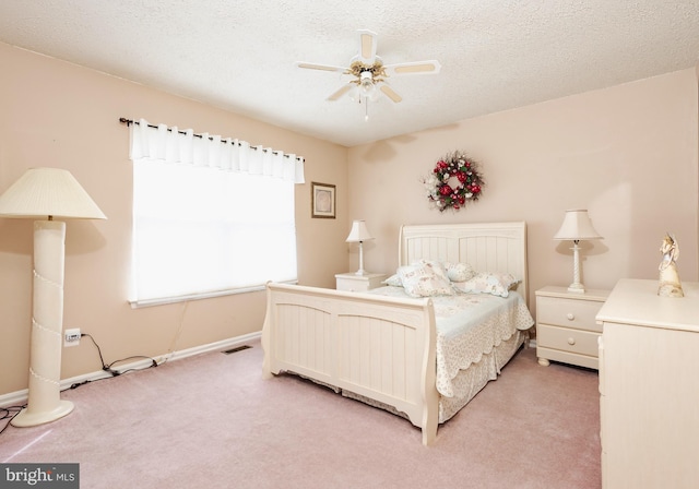 bedroom featuring ceiling fan, a textured ceiling, and carpet flooring