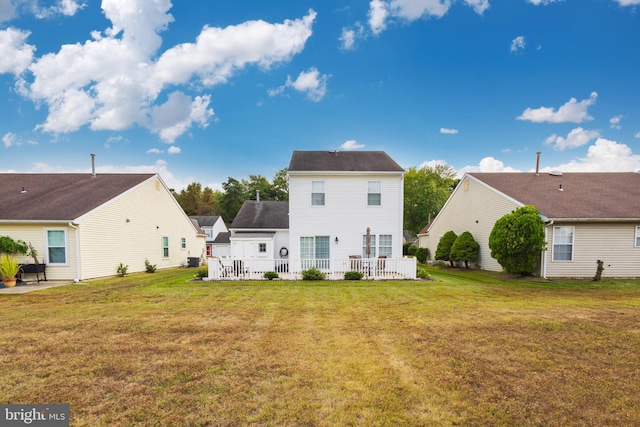 back of property featuring a lawn