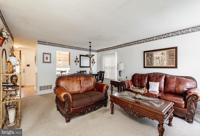 living room with light colored carpet and a textured ceiling