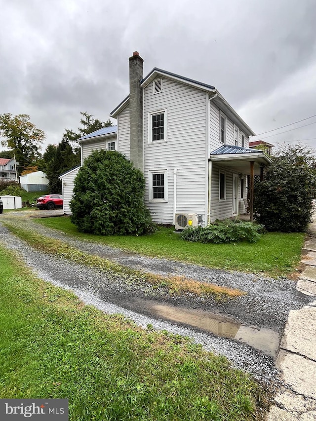 view of home's exterior featuring a yard and ac unit