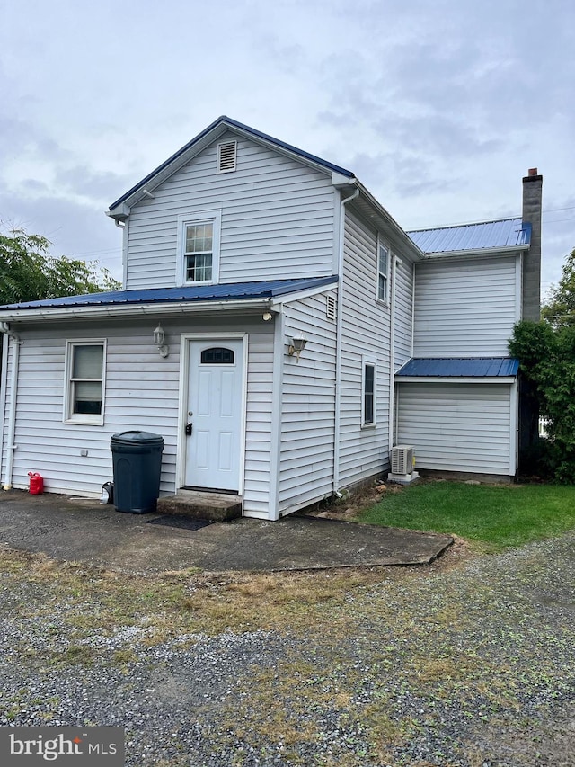 back of property featuring central AC