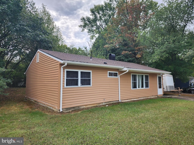 view of home's exterior with a lawn