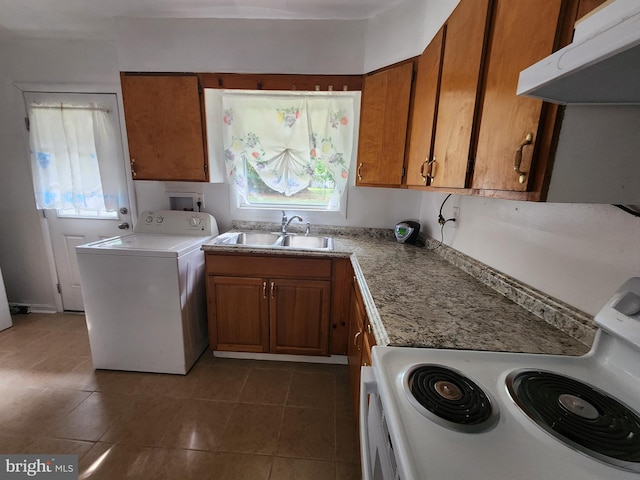 kitchen featuring dark tile patterned floors, washer / clothes dryer, electric range, ventilation hood, and sink