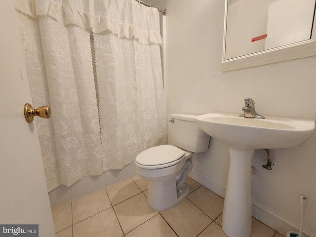 bathroom with tile patterned floors, toilet, and shower / tub combo with curtain