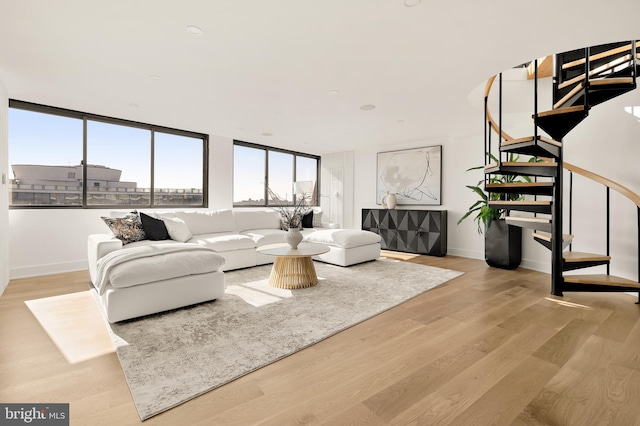 living room featuring floor to ceiling windows and light hardwood / wood-style flooring