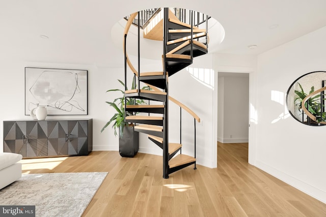 stairs featuring hardwood / wood-style floors