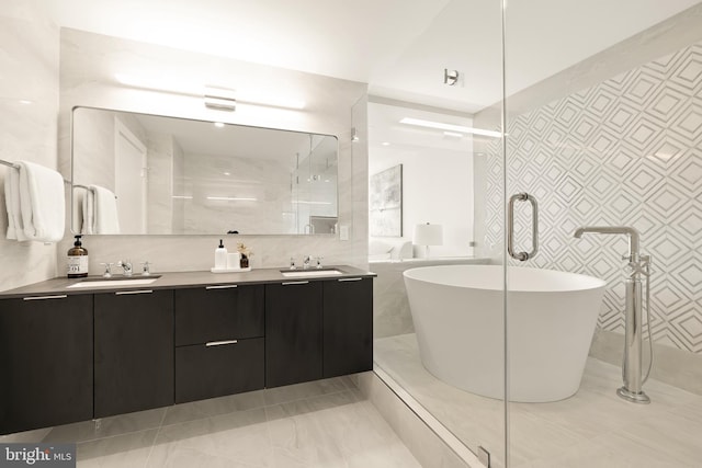 bathroom with vanity, tile walls, and separate shower and tub