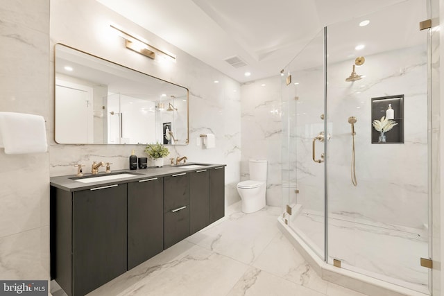 bathroom featuring vanity, a shower with shower door, and toilet