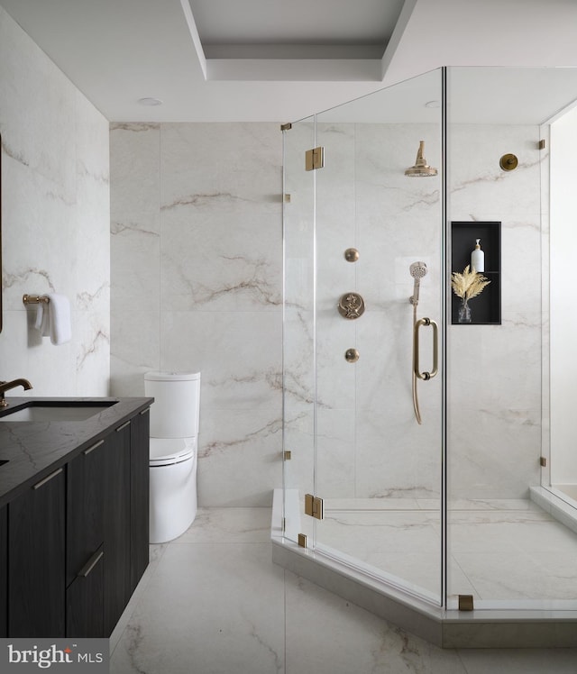 bathroom with vanity, toilet, and an enclosed shower