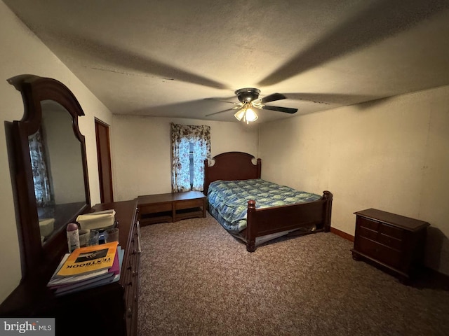 carpeted bedroom featuring ceiling fan and a textured ceiling