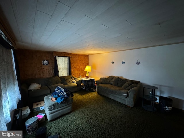 carpeted living room with wood walls