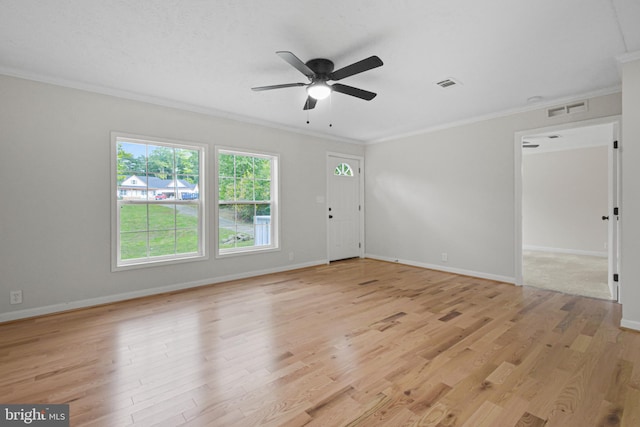 spare room featuring ornamental molding, light hardwood / wood-style floors, and ceiling fan