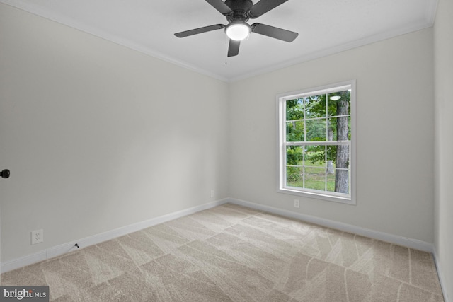 empty room with crown molding, light colored carpet, and ceiling fan