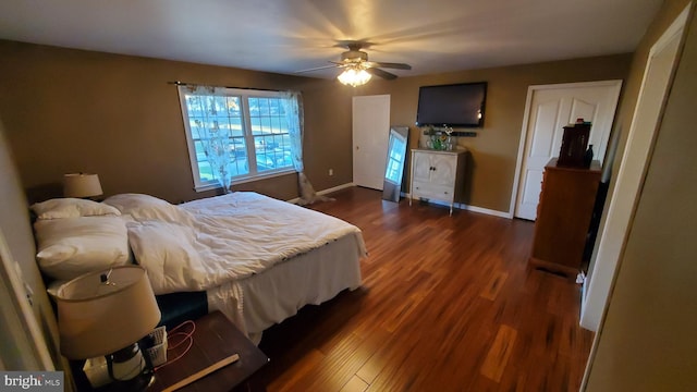 bedroom with ceiling fan and dark hardwood / wood-style floors