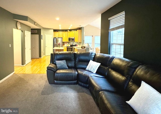 living room featuring light colored carpet and baseboards