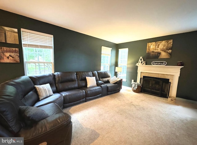 living area with carpet flooring and a glass covered fireplace