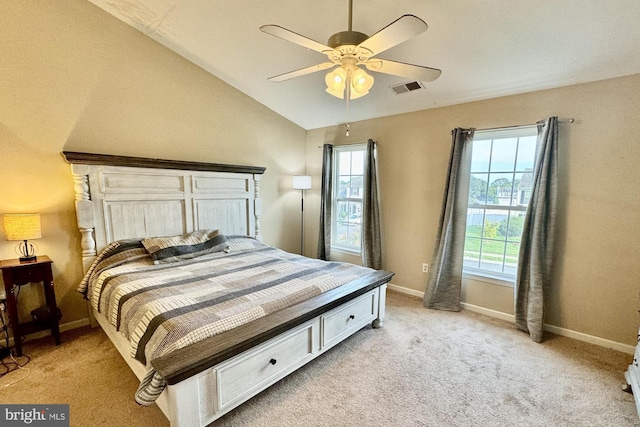 bedroom featuring lofted ceiling, baseboards, multiple windows, and visible vents