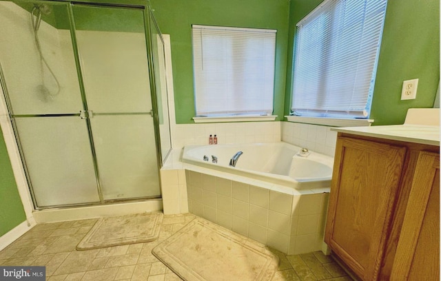 bathroom with independent shower and bath, vanity, and tile patterned flooring