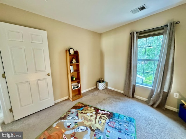 interior space with baseboards, visible vents, and carpet flooring