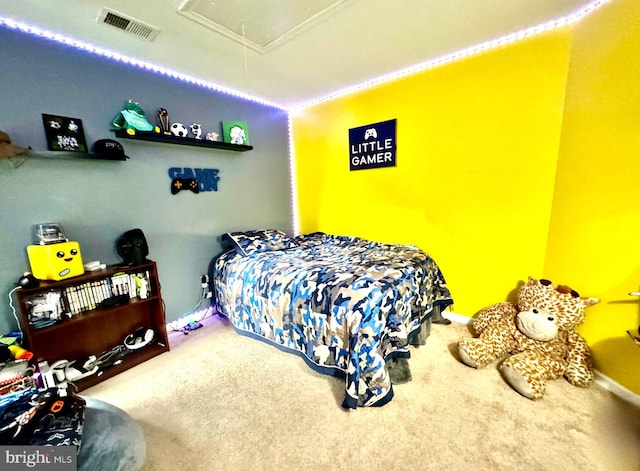 carpeted bedroom with attic access and visible vents