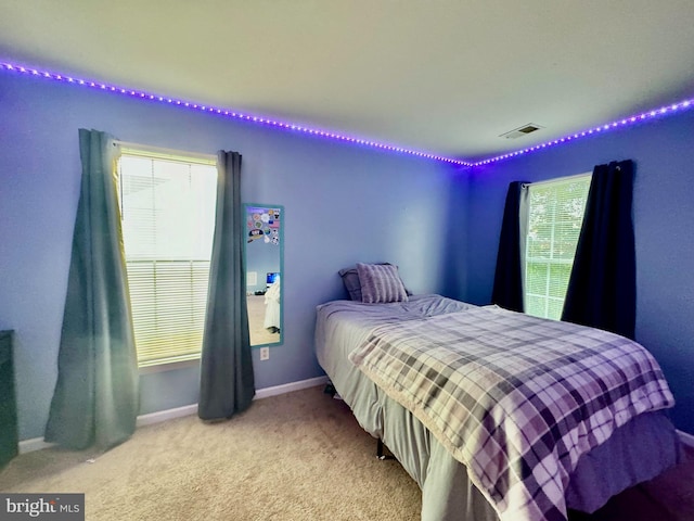 carpeted bedroom with baseboards and visible vents