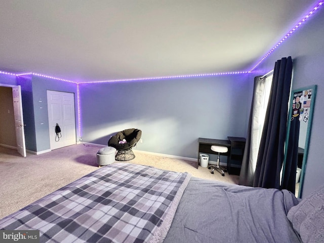 bedroom with carpet floors and baseboards