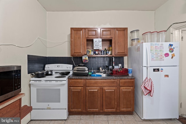 kitchen with white appliances, light tile patterned floors, tasteful backsplash, and sink