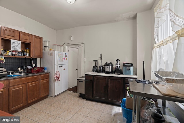 kitchen featuring light tile patterned floors and white fridge