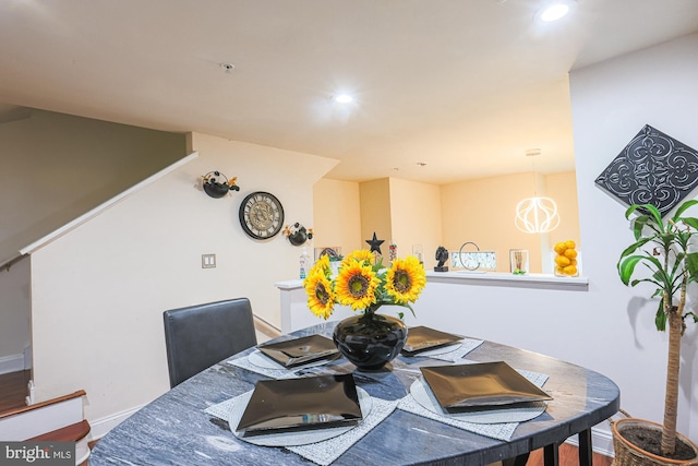 dining room featuring a notable chandelier and hardwood / wood-style flooring