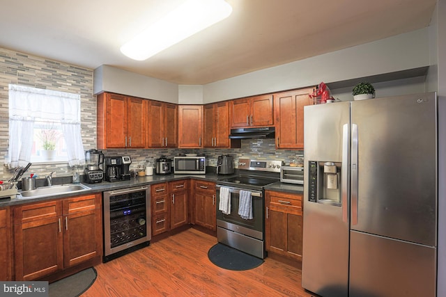 kitchen with backsplash, stainless steel appliances, beverage cooler, dark hardwood / wood-style floors, and sink