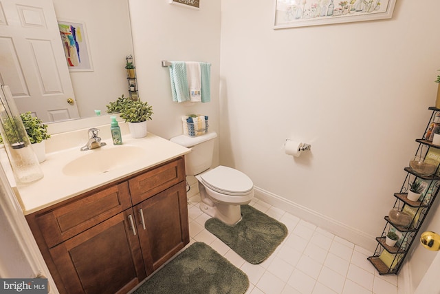 bathroom with tile patterned flooring, vanity, and toilet