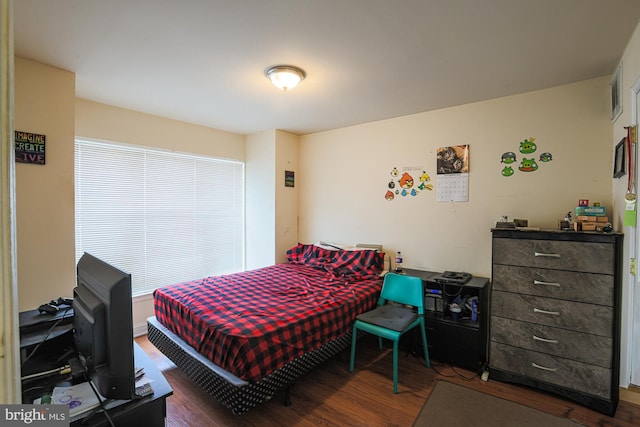 bedroom with dark wood-type flooring