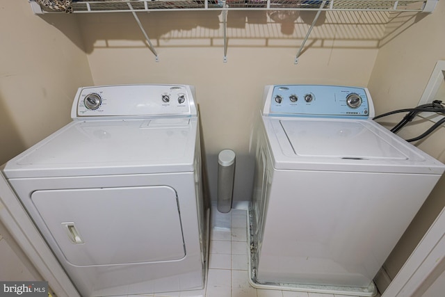 laundry room with separate washer and dryer and light tile patterned floors