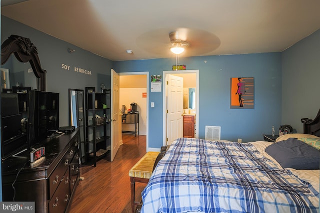 bedroom with connected bathroom, ceiling fan, and dark hardwood / wood-style flooring