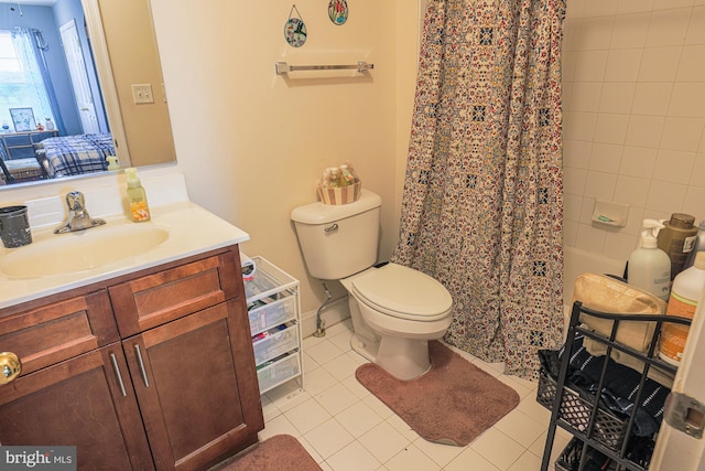 bathroom with tile patterned flooring, vanity, and toilet