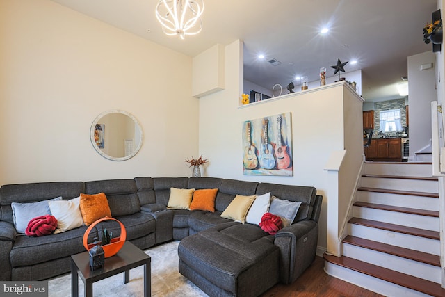 living room with wood-type flooring and a chandelier