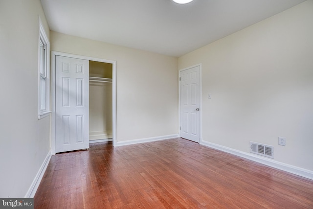 unfurnished bedroom featuring a closet and wood-type flooring