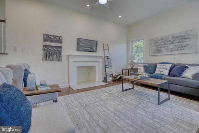 living room with hardwood / wood-style floors and ceiling fan