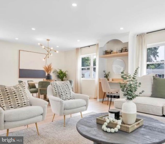 living room featuring light hardwood / wood-style floors and a notable chandelier