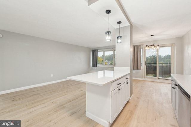 kitchen with hanging light fixtures, a kitchen island, stainless steel dishwasher, light hardwood / wood-style flooring, and white cabinetry