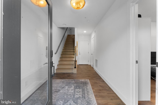 staircase featuring hardwood / wood-style floors