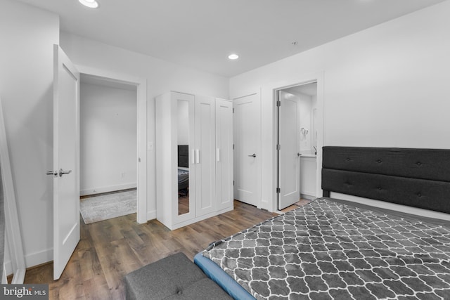 bedroom with dark wood-type flooring