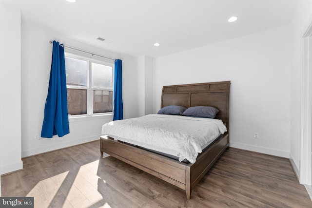 bedroom with hardwood / wood-style floors