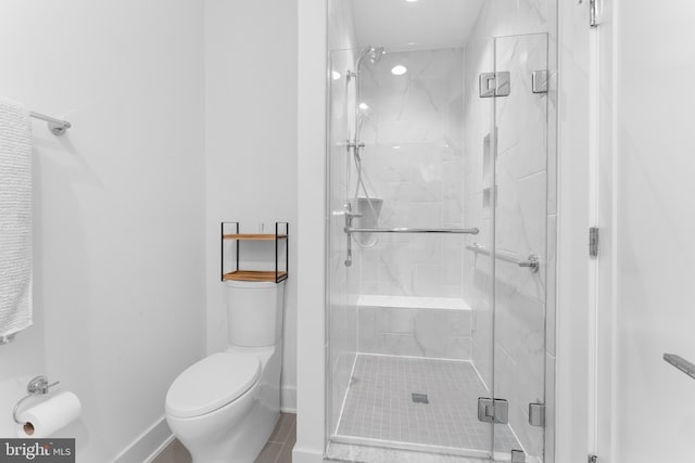 bathroom with tile patterned flooring, a shower with shower door, and toilet