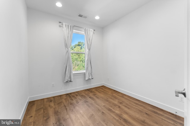 spare room with hardwood / wood-style flooring