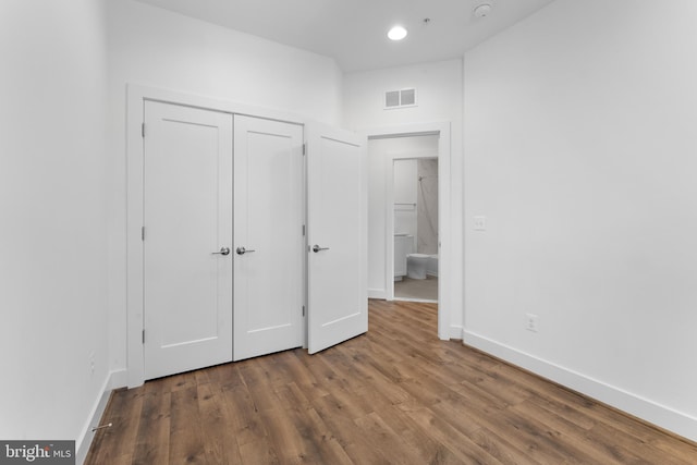 unfurnished bedroom with wood-type flooring