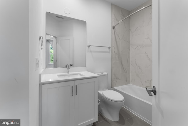 full bathroom featuring vanity, tiled shower / bath combo, toilet, and tile patterned flooring